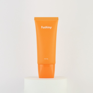 Orange oval cream tube with screw cap labeled "fushiny" and "net 50g"