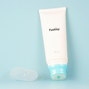 Cosmetic tube with brush applicator for facial cleanser