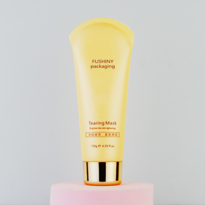 lotion squeeze tube with gold screw cap, printed "fushiny packaging and mask"